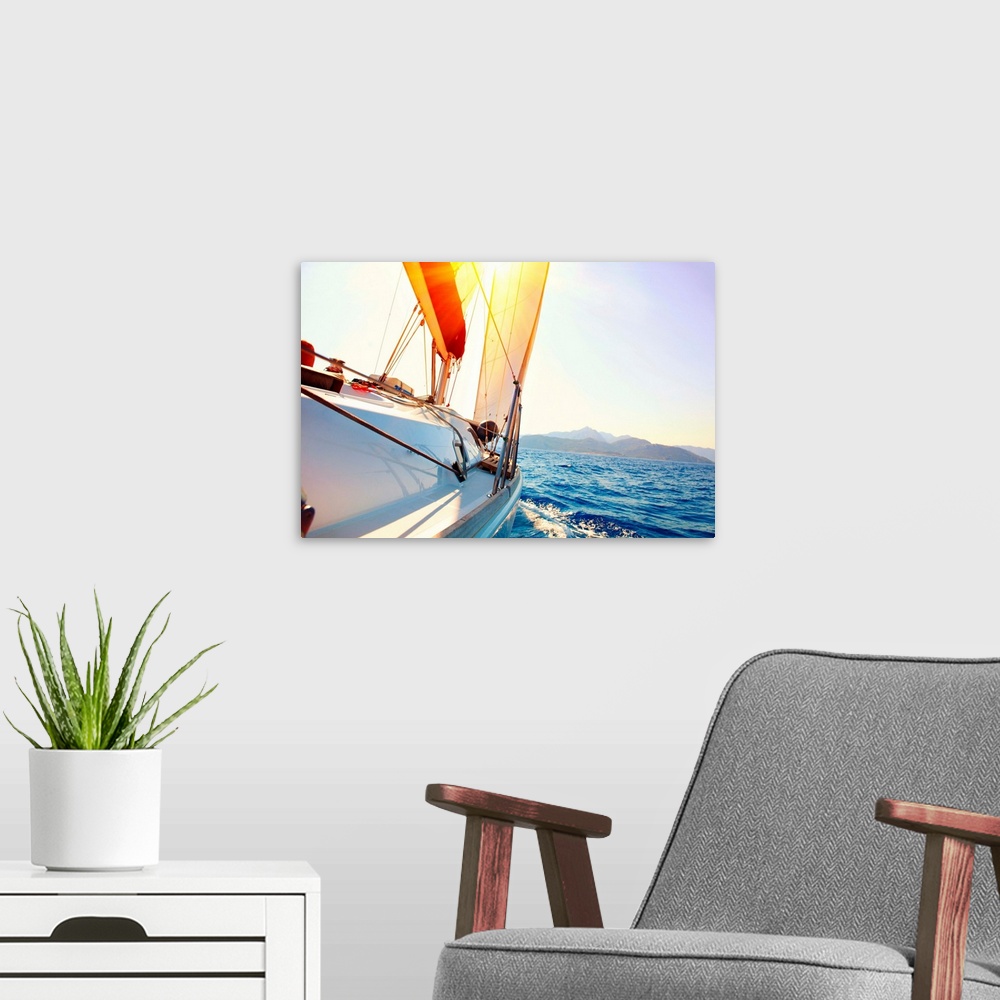 A modern room featuring Yacht Sailing against sunset. Sailboat. Yachting. Sailing. Travel Concept. Vacation