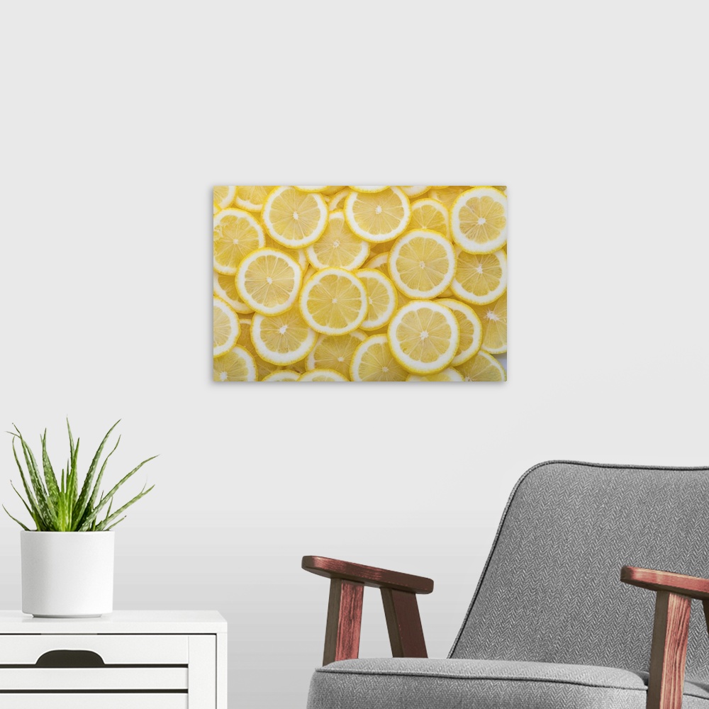 A modern room featuring Yellow sliced lemons places on a table overlapping each other. Background texture of fresh yellow...
