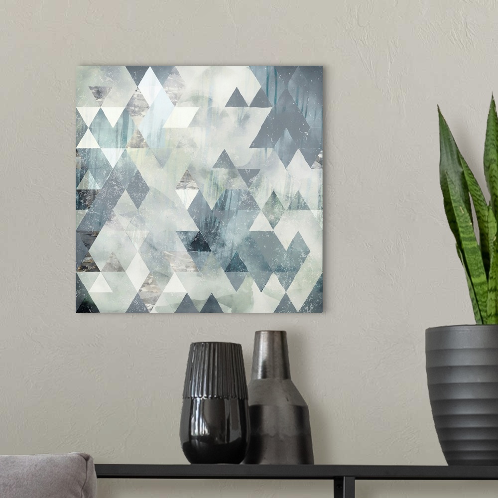A modern room featuring Abstract geometric design with triangles, grey, ivory and blue.
