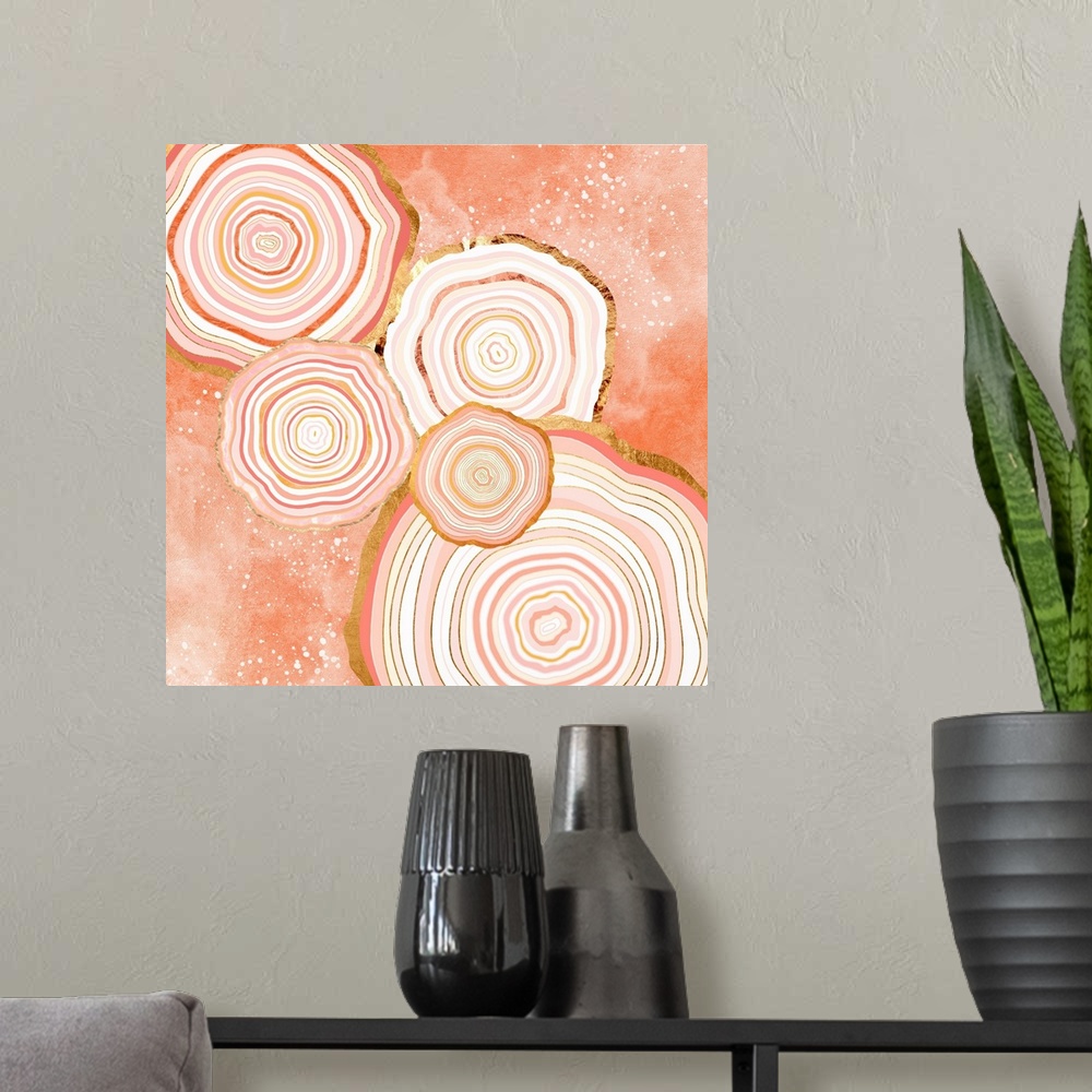 A modern room featuring Abstract depiction of agate slices with coral, gold, pink and white.