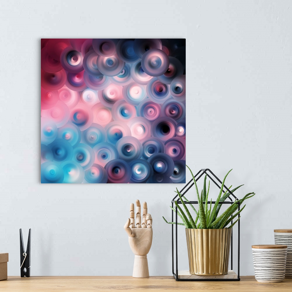 A bohemian room featuring Abstract artwork of overlapping swirling circles in bright shades of blue and pink mixed with dar...