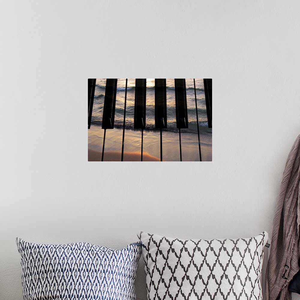 A bohemian room featuring Big photograph focuses on the keys of a piano that have another picture of a sea crashing into a ...