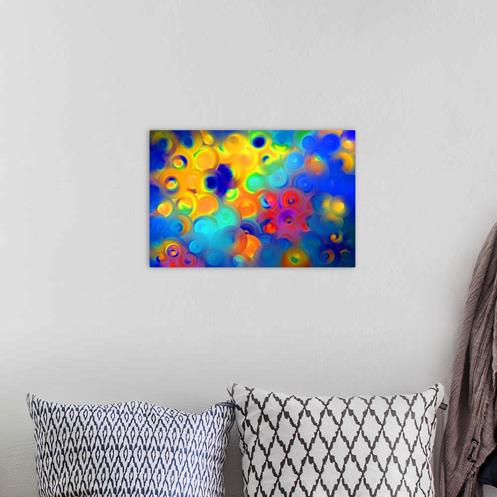 A bohemian room featuring Abstract artwork of overlapping swirling circles in vibrant yellow, red, and blue.
