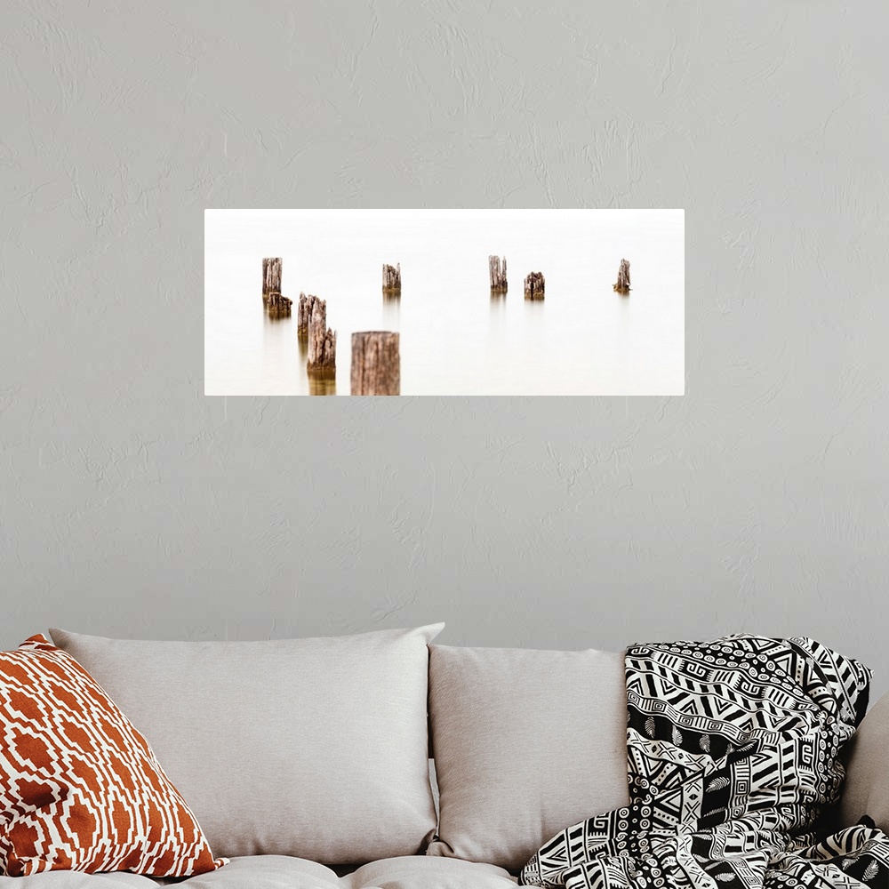 A bohemian room featuring Abandoned dock pilings along Okanagan Lake, Canada creating a minimalist image.