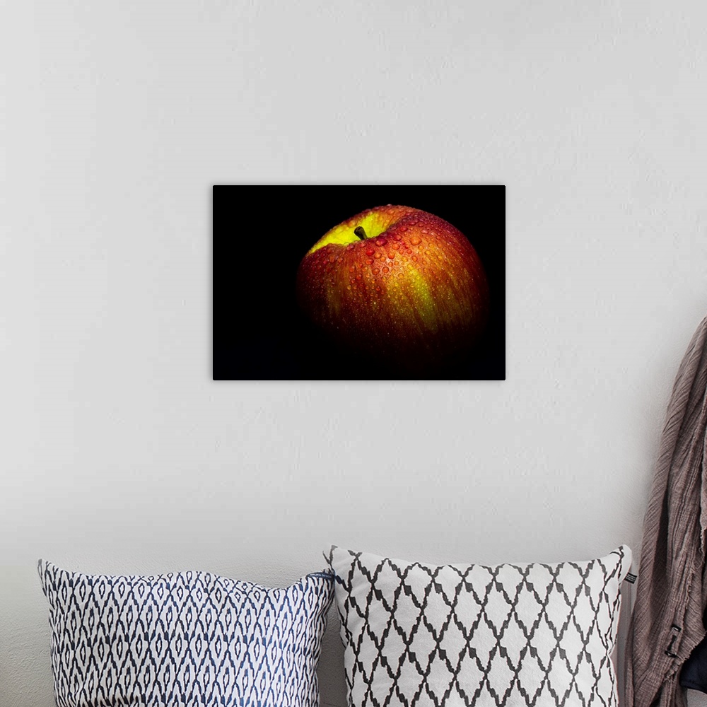 A bohemian room featuring A close up photograph of a fresh Gala apple with waterdrops.