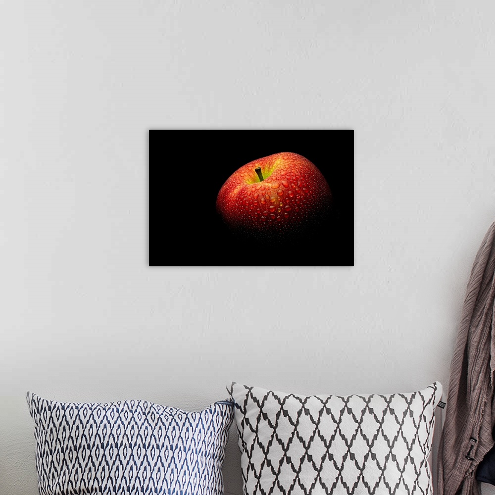 A bohemian room featuring A close up photograph of a fresh Honeycrisp apple with waterdrops.