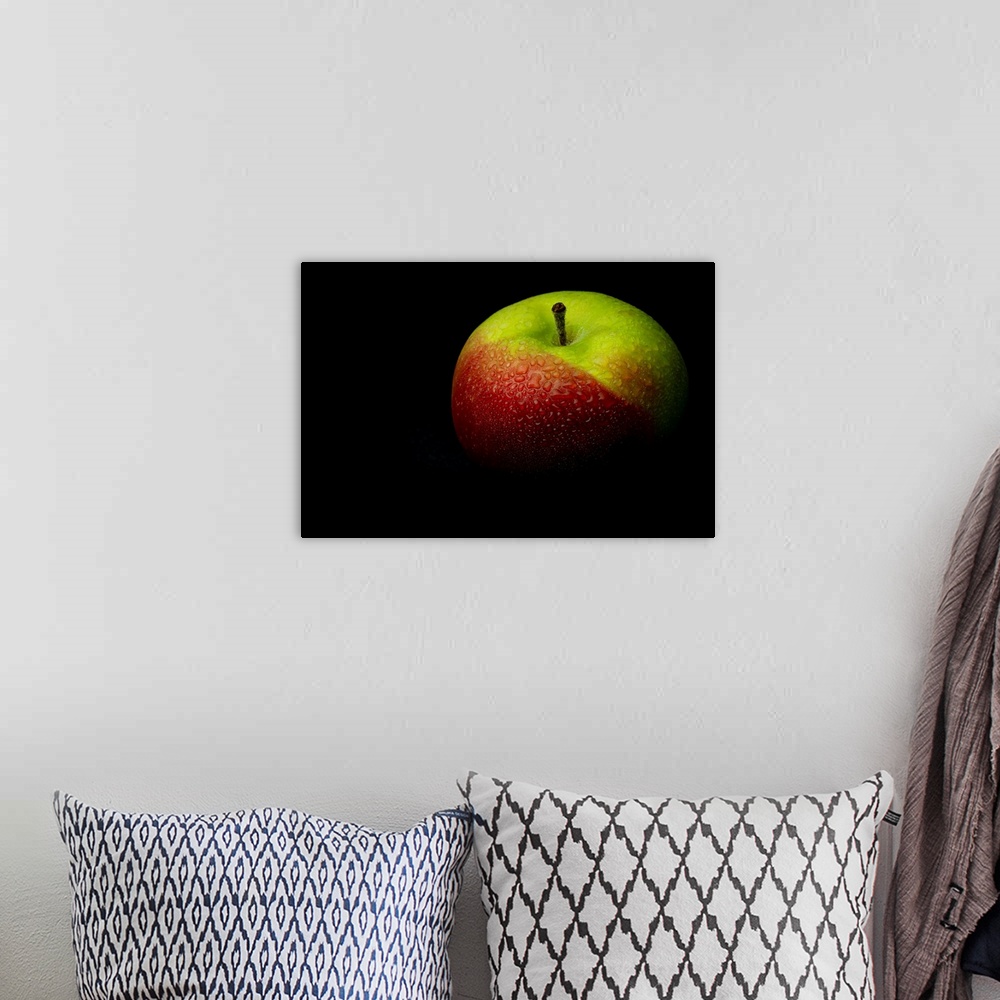A bohemian room featuring A close up photograph of a fresh Macintosh apple with waterdrops.