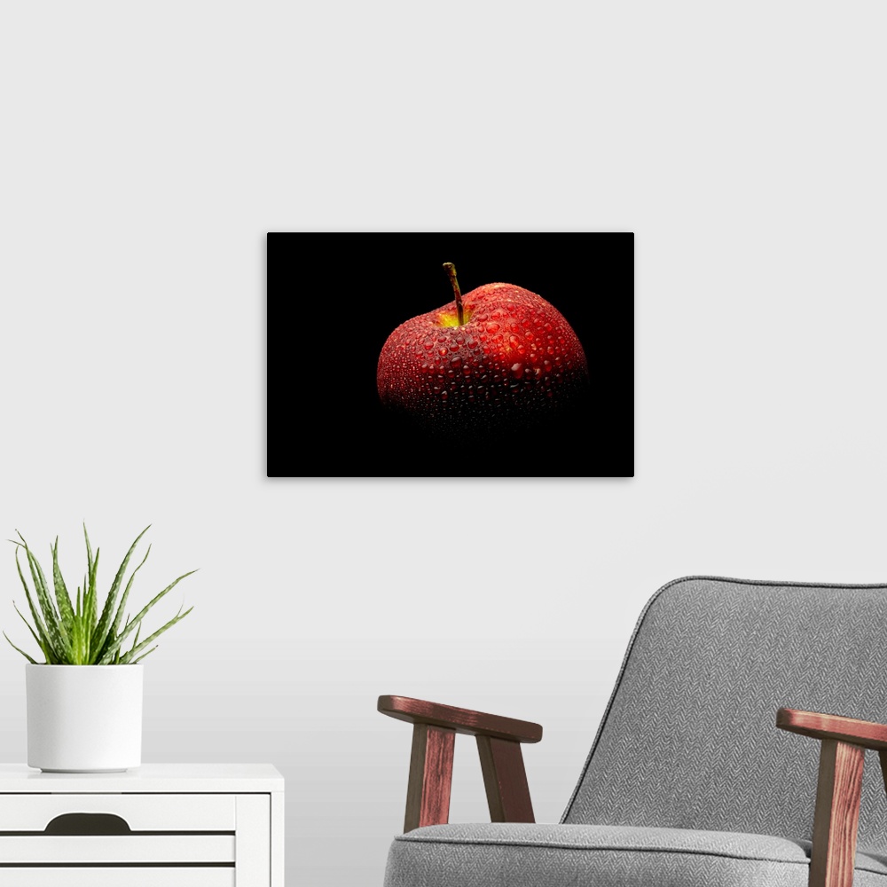 A modern room featuring A close up photograph of a fresh Red Delicious apple with waterdrops.