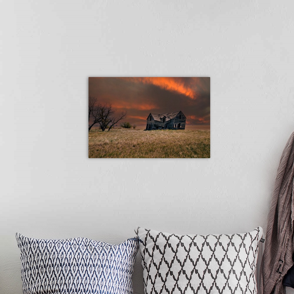 A bohemian room featuring An old abandoned farm house with stormy skies at sunset in the Canadian prairies.