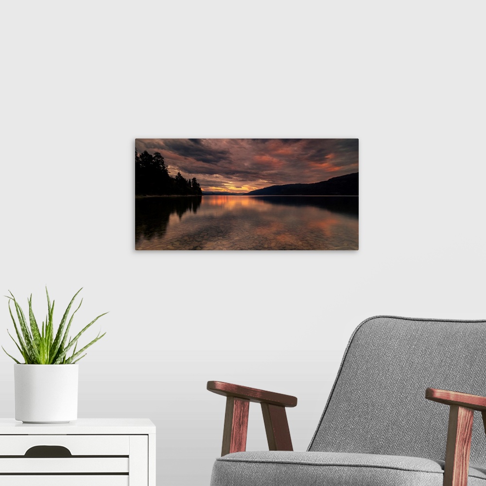 A modern room featuring Sunset modeled skies reflecting off Okanagan Lake in British Columbia, Canada.