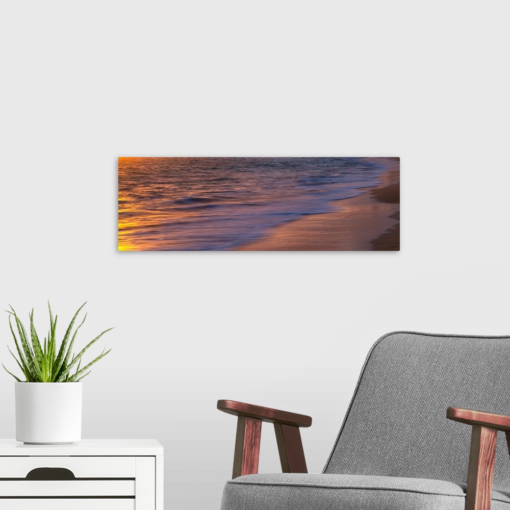A modern room featuring A abstract image of sunrise reflecting of a Pacific Ocean beach in Hawaii.
