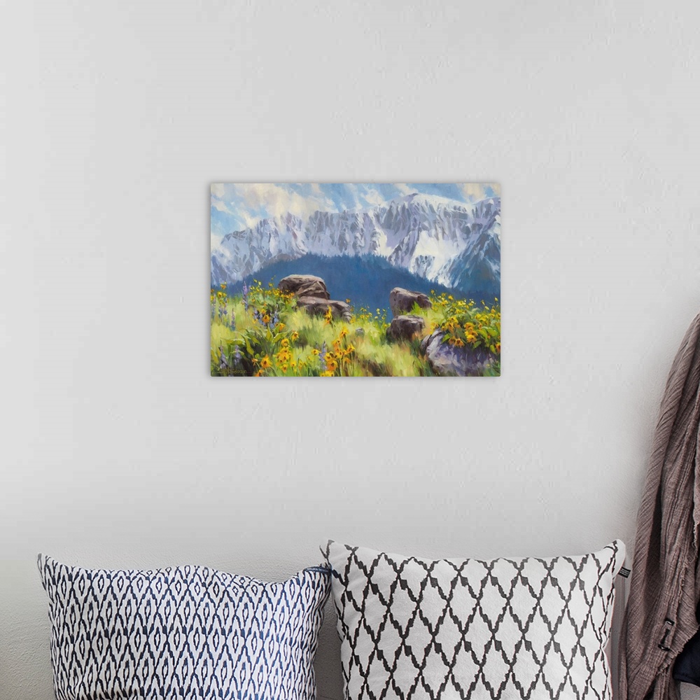 A bohemian room featuring Traditional representational landscape painting of snow-capped mountains and a sunlit meadow of w...
