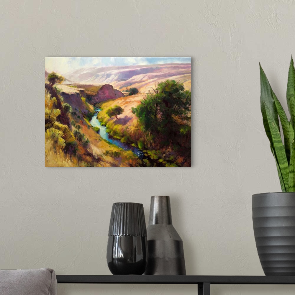A modern room featuring Traditional representational landscape painting of a shallow canyon with a river running through ...