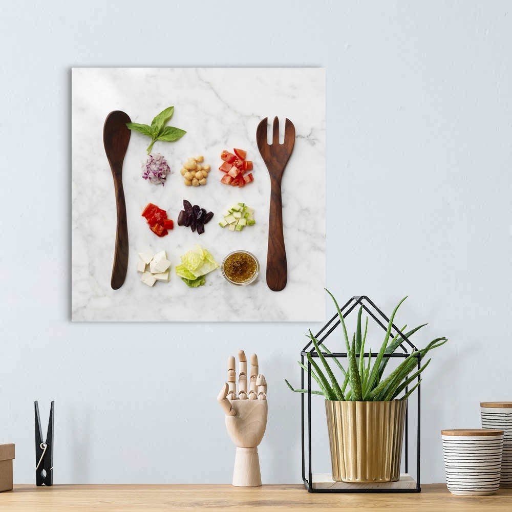 A bohemian room featuring Chopped salad ingredients with salad servers on a marble surface