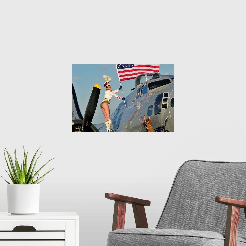 A modern room featuring Patriotic 1940's style majorette pin-up girl standing on a B-17 bomber with an American flag.
