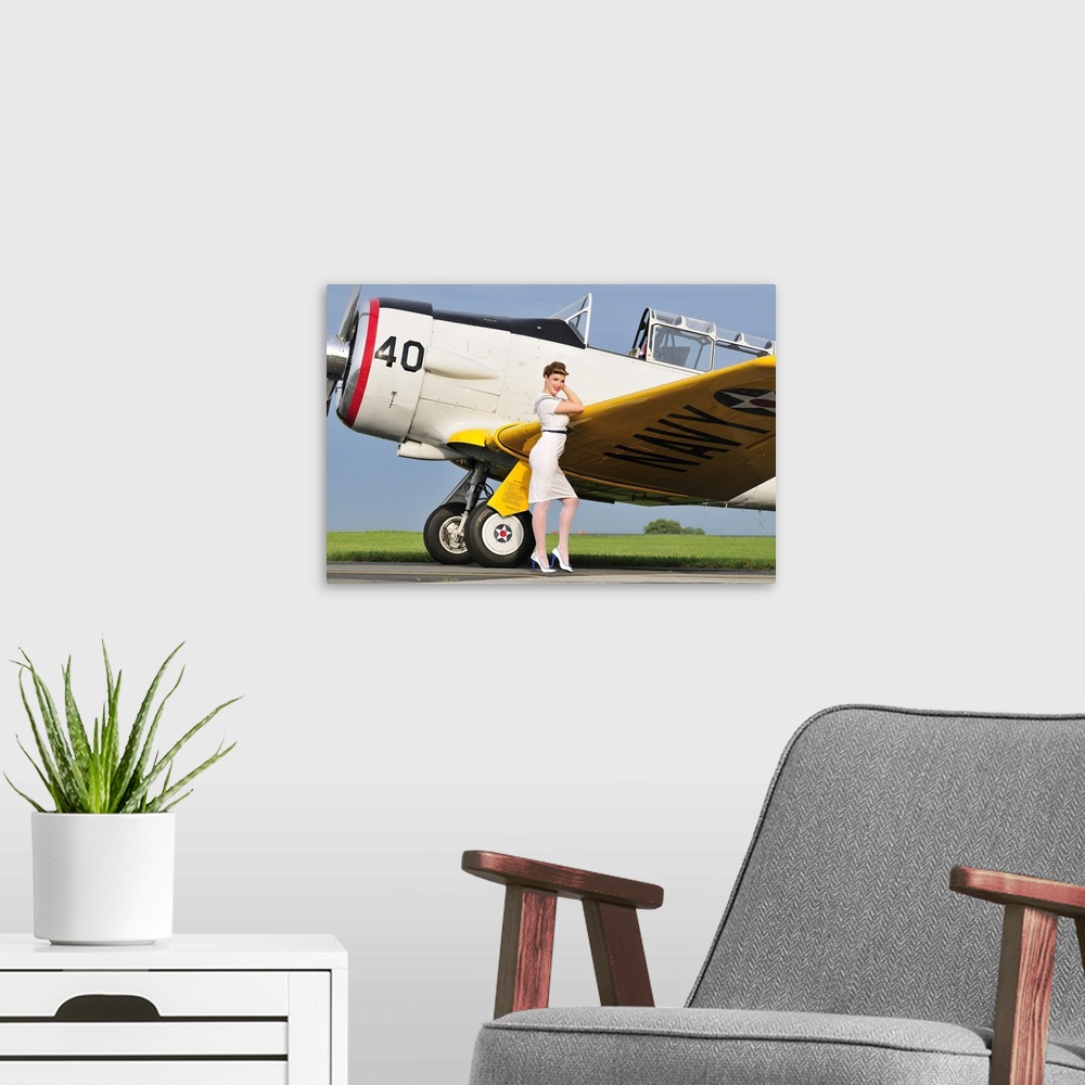 A modern room featuring 1940's style Navy pin-up girl leaning on the wing of a T-6 Texan trainer aircraft.