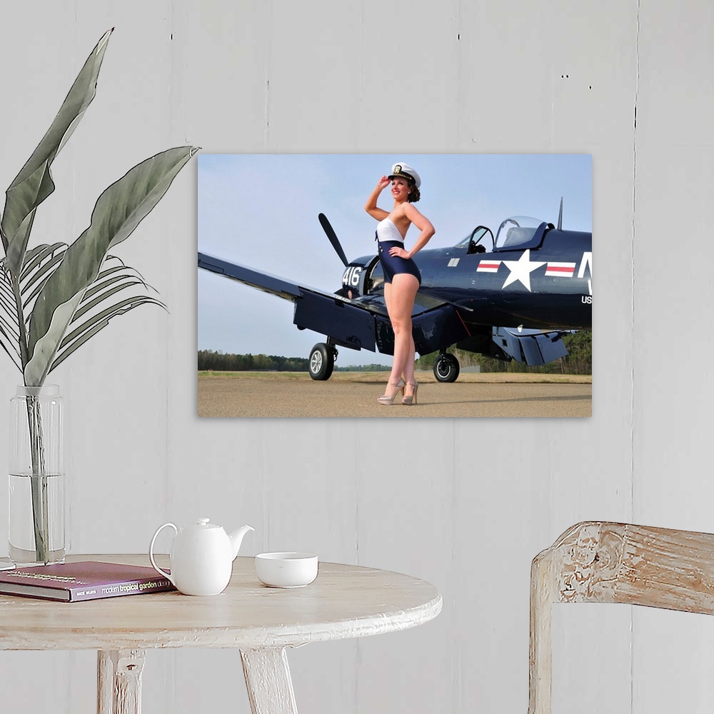 A farmhouse room featuring Beautiful 1940's style Navy pin-up girl posing with a vintage Corsair aircraft.