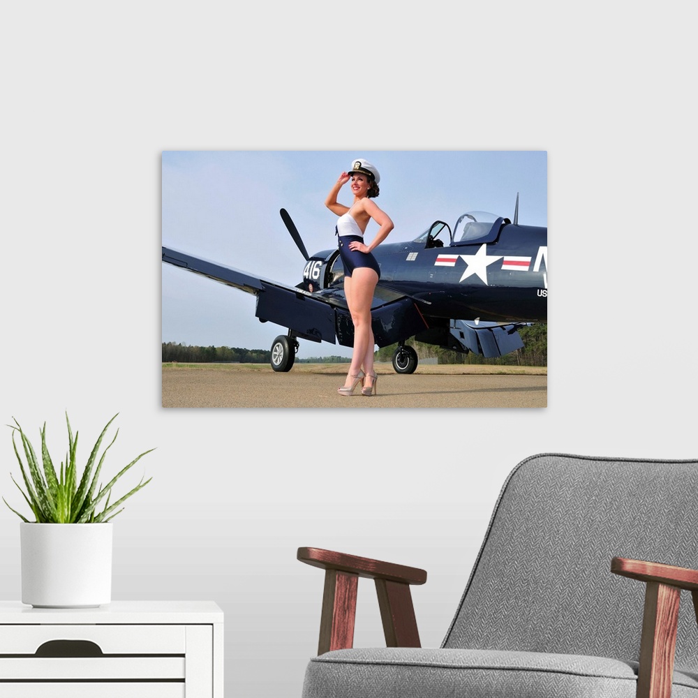 A modern room featuring Beautiful 1940's style Navy pin-up girl posing with a vintage Corsair aircraft.