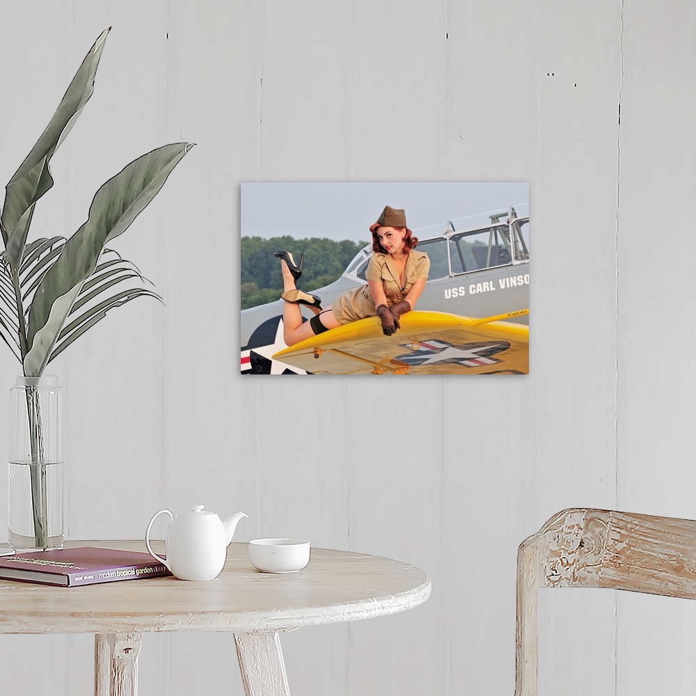 A farmhouse room featuring 1940's style pin-up girl lying on a T-6 Texan training aircraft.