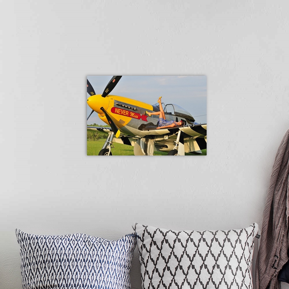 A bohemian room featuring 1940's style pin-up girl lying on the wing of a P-51 Mustang fighter plane.