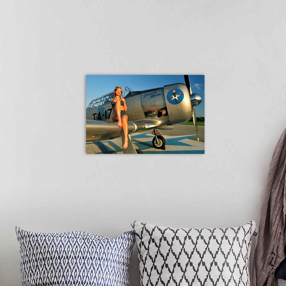 A bohemian room featuring 1940's style pin-up girl sitting on the wing of a World War II T-6 Texan.