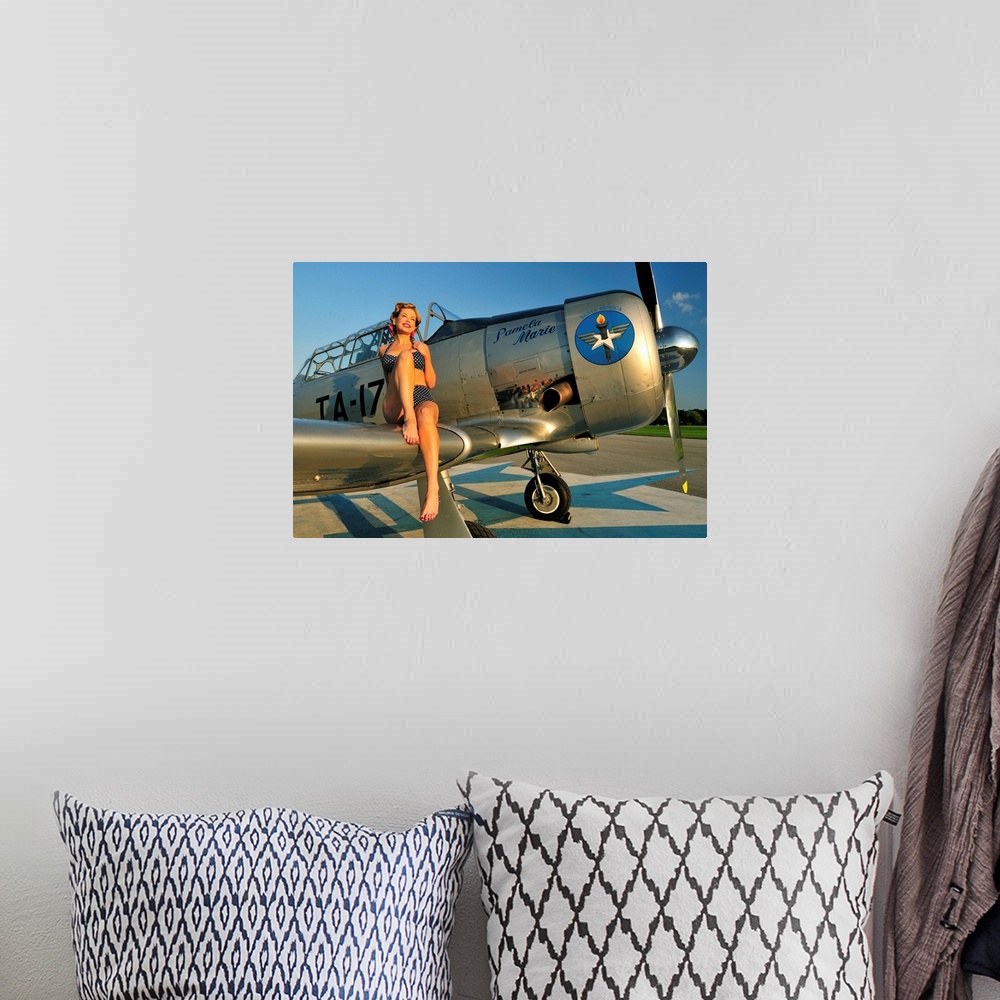 A bohemian room featuring 1940's style pin-up girl sitting on the wing of a World War II T-6 Texan.