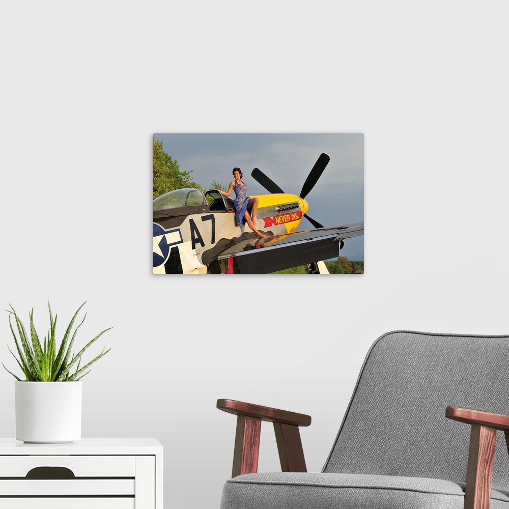 A modern room featuring Beautiful 1940's style pin-up girl standing barefoot on the wing of a P-51 Mustang.