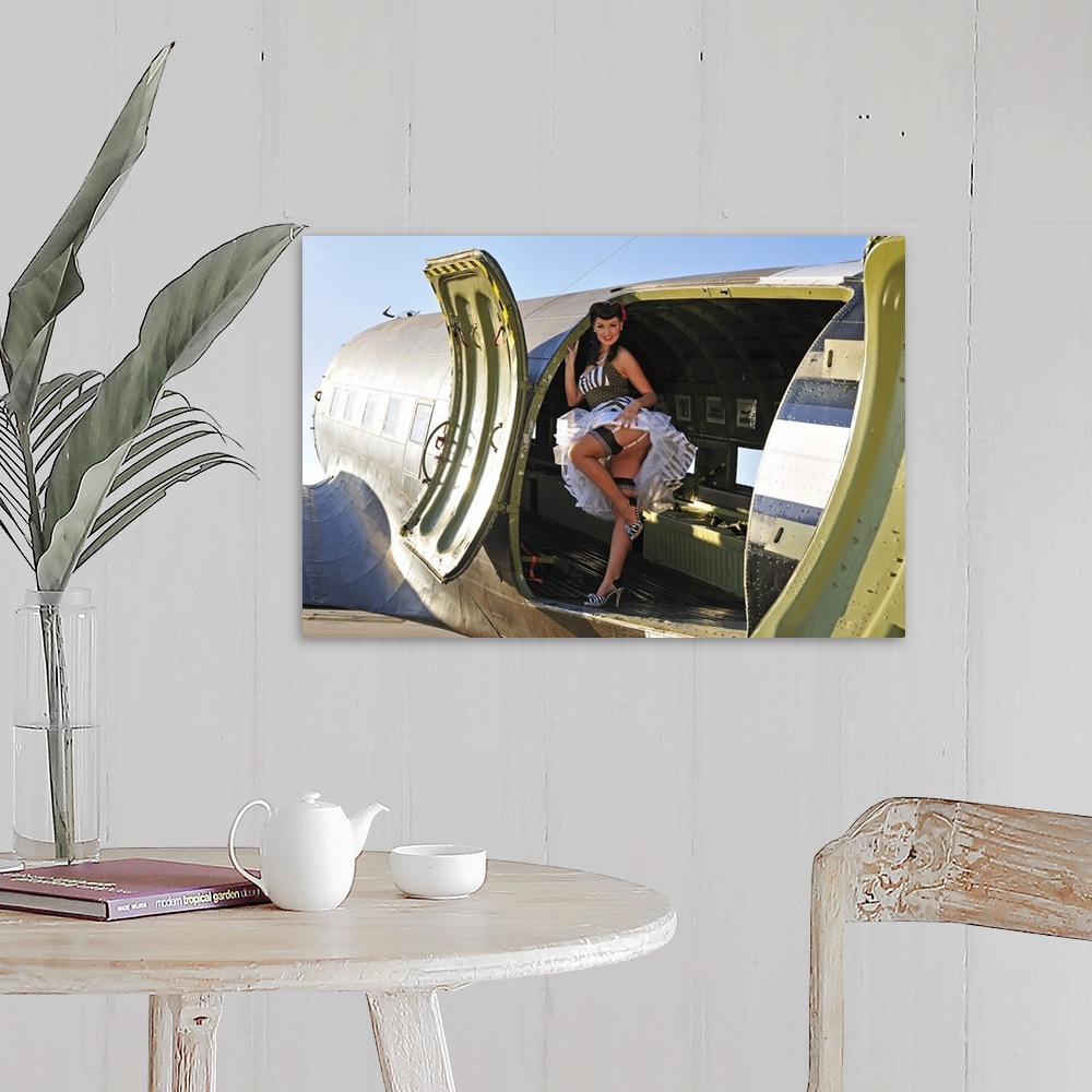 A farmhouse room featuring Sexy 1940's style pin-up girl with stockings, standing inside of a World War II C-47 Skytrain air...