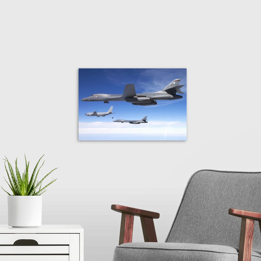 A modern room featuring A B-1B Lancer stands by as another Lancer connects with a KC-135 Stratotanker.