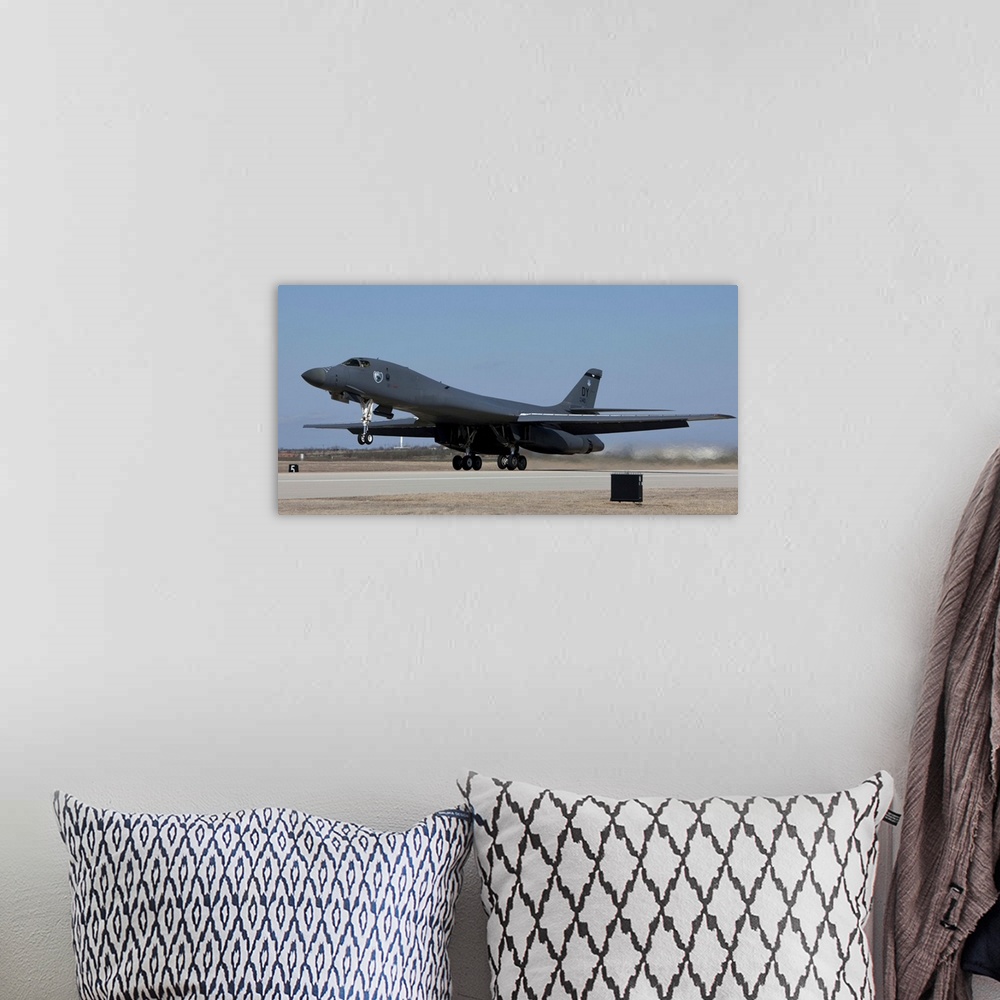 A bohemian room featuring A 7th Bomb Wing B-1B Lancer takes off in the late afternoon from Dyess Air Force Base, Texas.