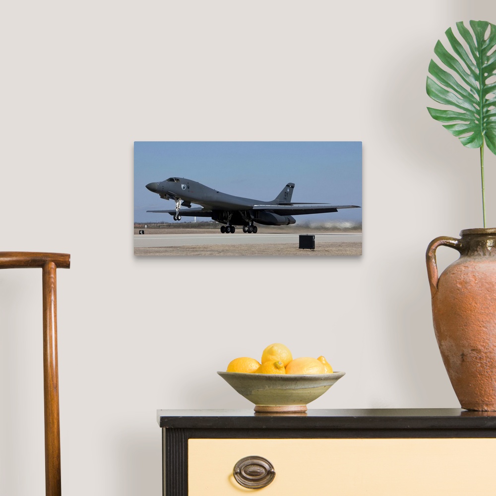 A traditional room featuring A 7th Bomb Wing B-1B Lancer takes off in the late afternoon from Dyess Air Force Base, Texas.