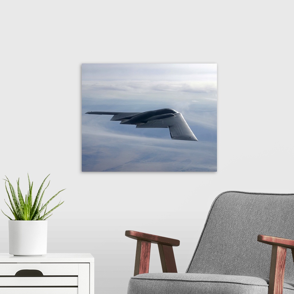 A modern room featuring A B-2 Spirit soars through the sky.