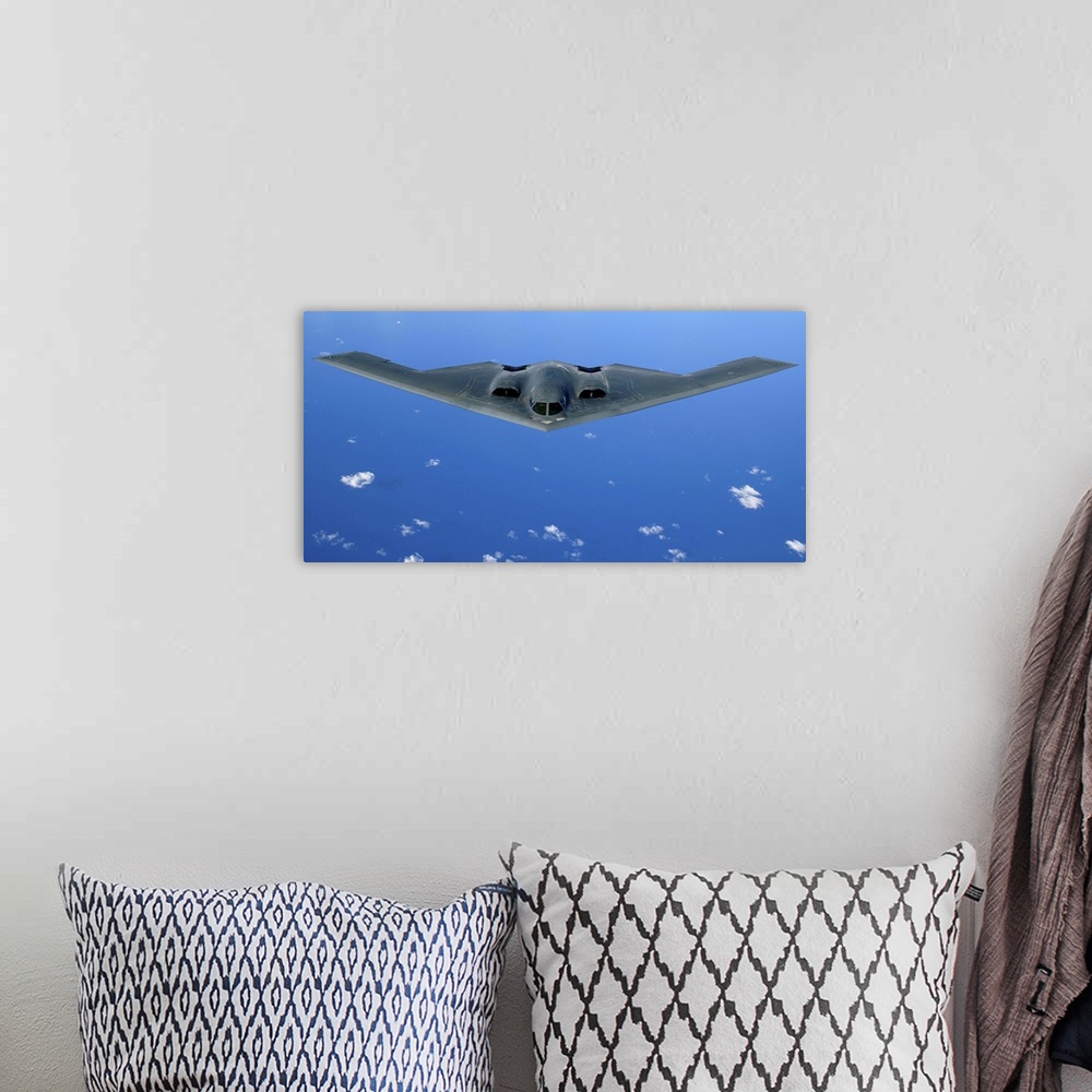A bohemian room featuring A B-2 Spirit soars through the sky after a refueling mission.