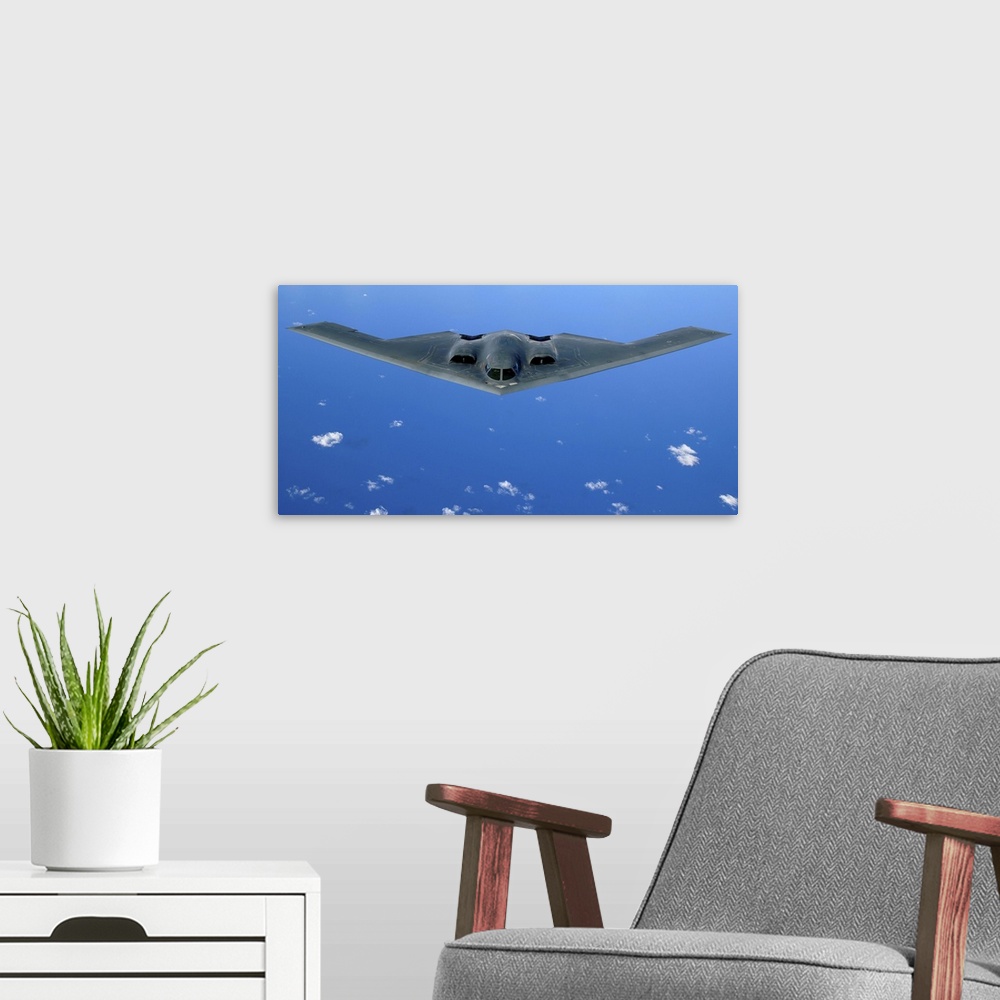 A modern room featuring A B-2 Spirit soars through the sky after a refueling mission.
