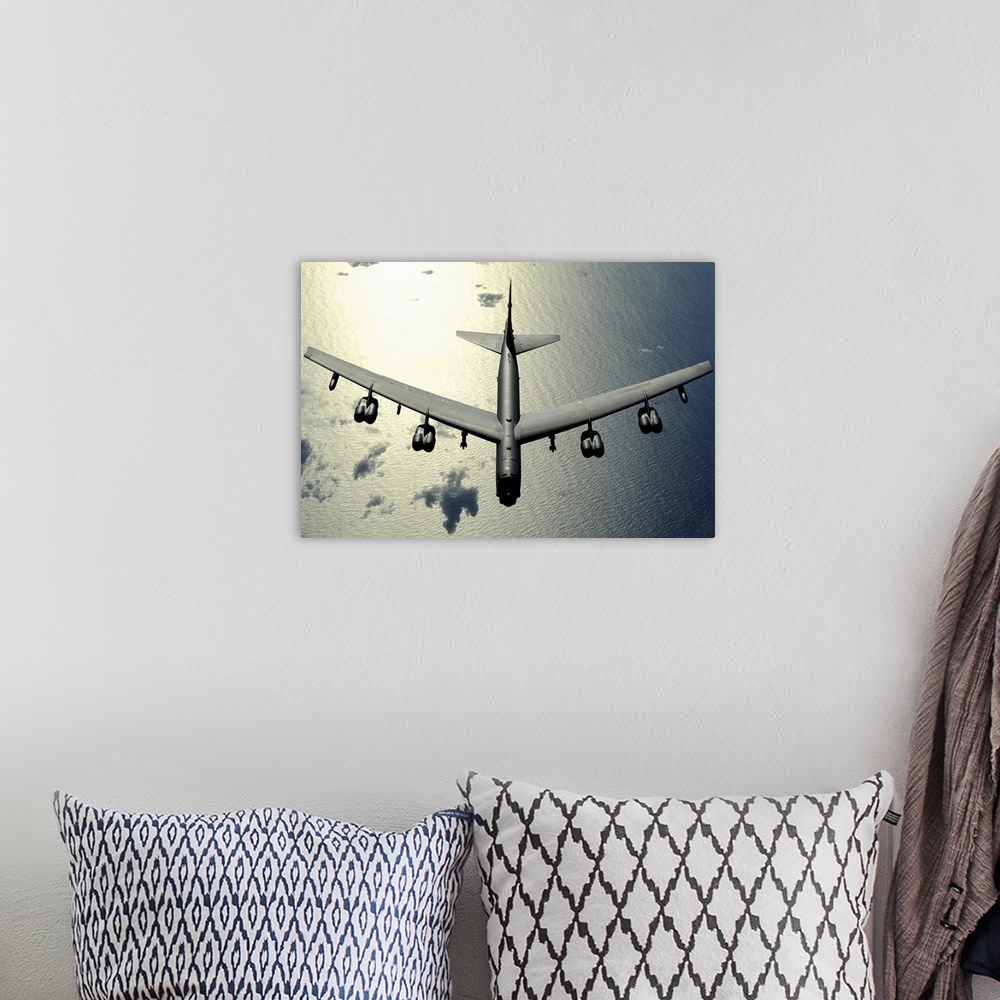 A bohemian room featuring Horizontal aerial photograph on a  big wall hanging, looking down at the top of a B52 Stratofortr...