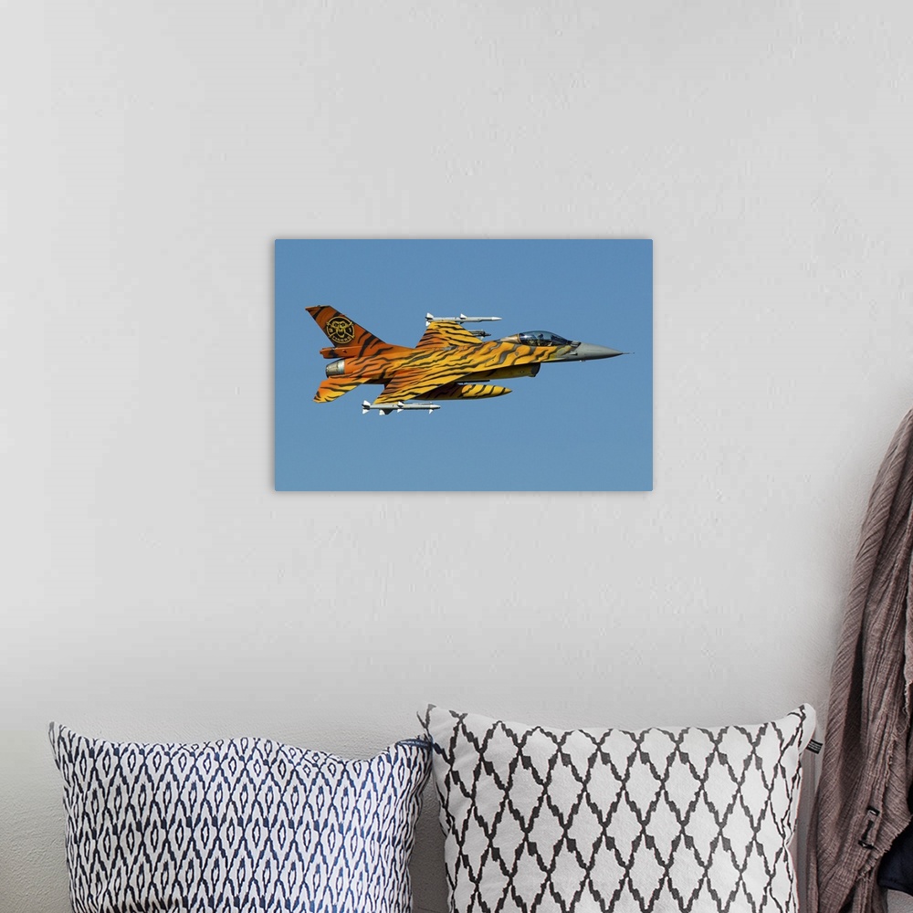 A bohemian room featuring A Belgian Air Component F-16 Fighting Falcon, painted in tiger colors for the NATO Tiger Meet, in...