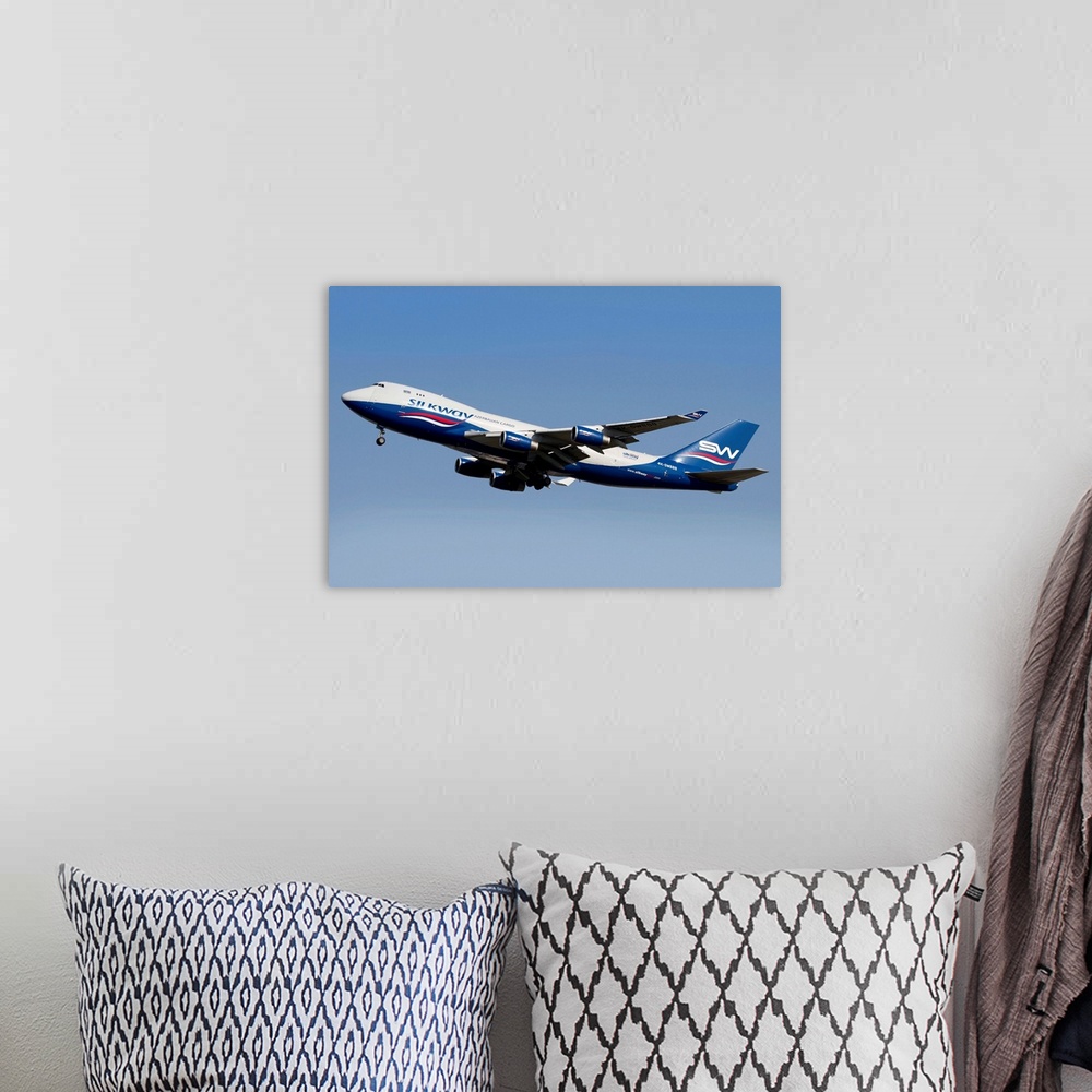 A bohemian room featuring A Boeing 747-400 of Slik Way Airlines in flight over Italy.
