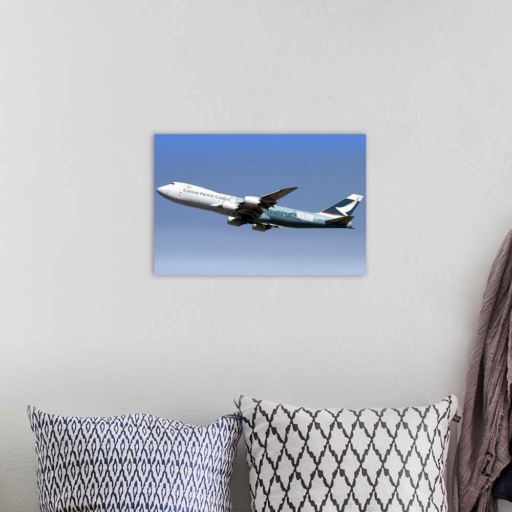 A bohemian room featuring A Boeing 747-800 Cathay Pacific Cargo Hong Kong Trader in flight over Italy.