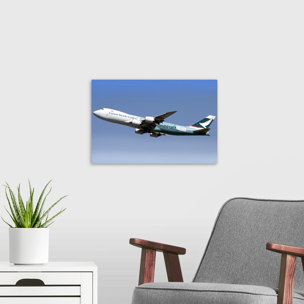 A modern room featuring A Boeing 747-800 Cathay Pacific Cargo Hong Kong Trader in flight over Italy.