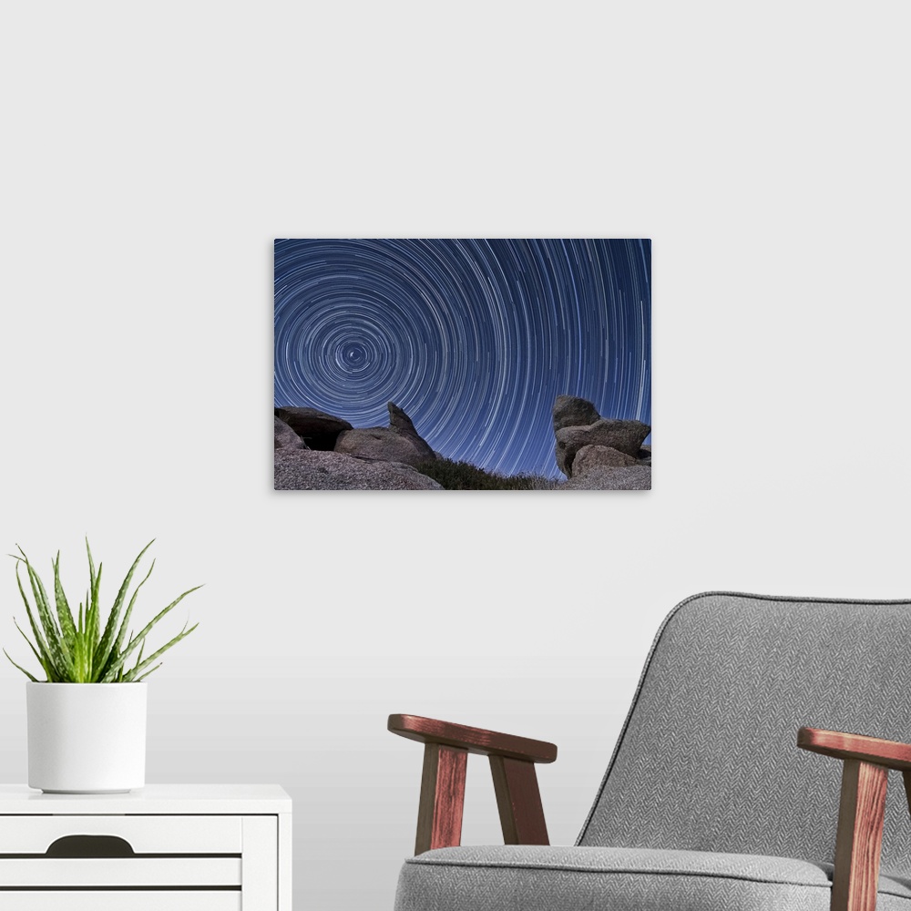 A modern room featuring A boulder outcropping and star trails in the high desert of Anza Borrego Desert State Park, Calif...