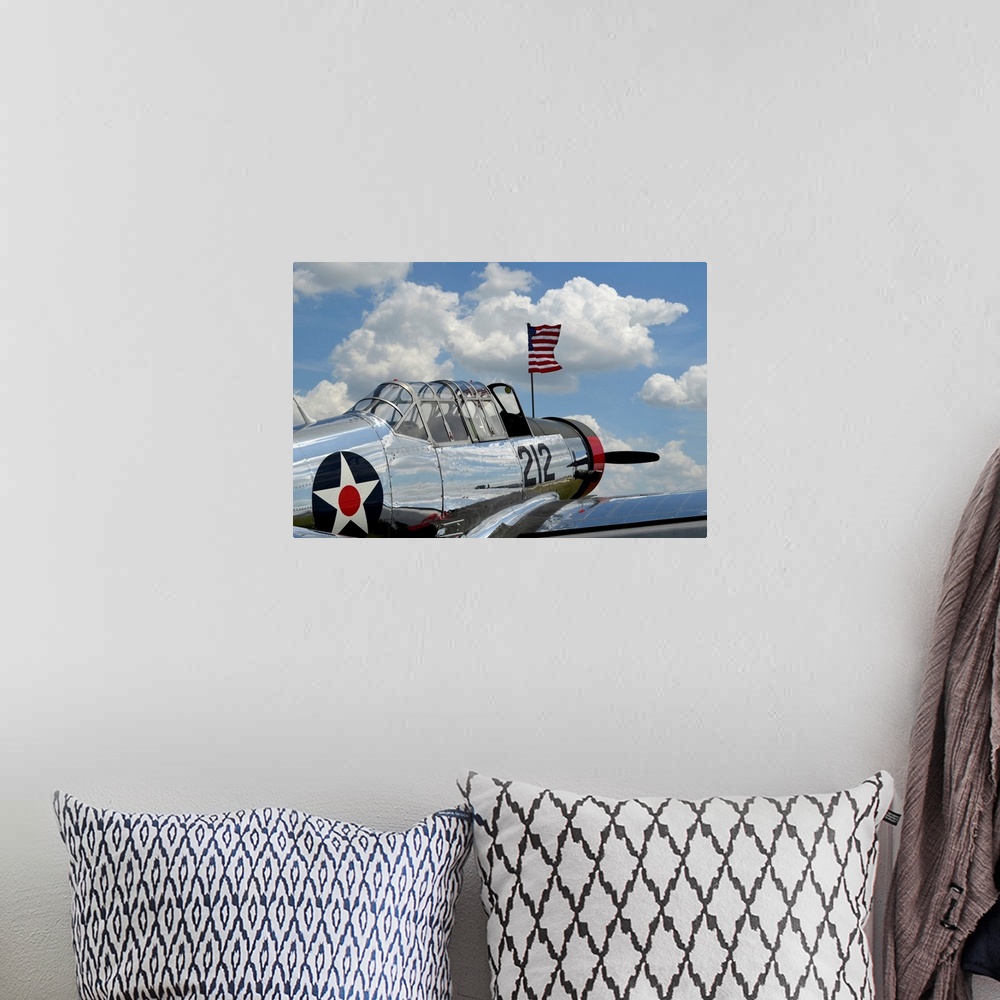 A bohemian room featuring A BT-13 Valiant trainer aircraft with American Flag.