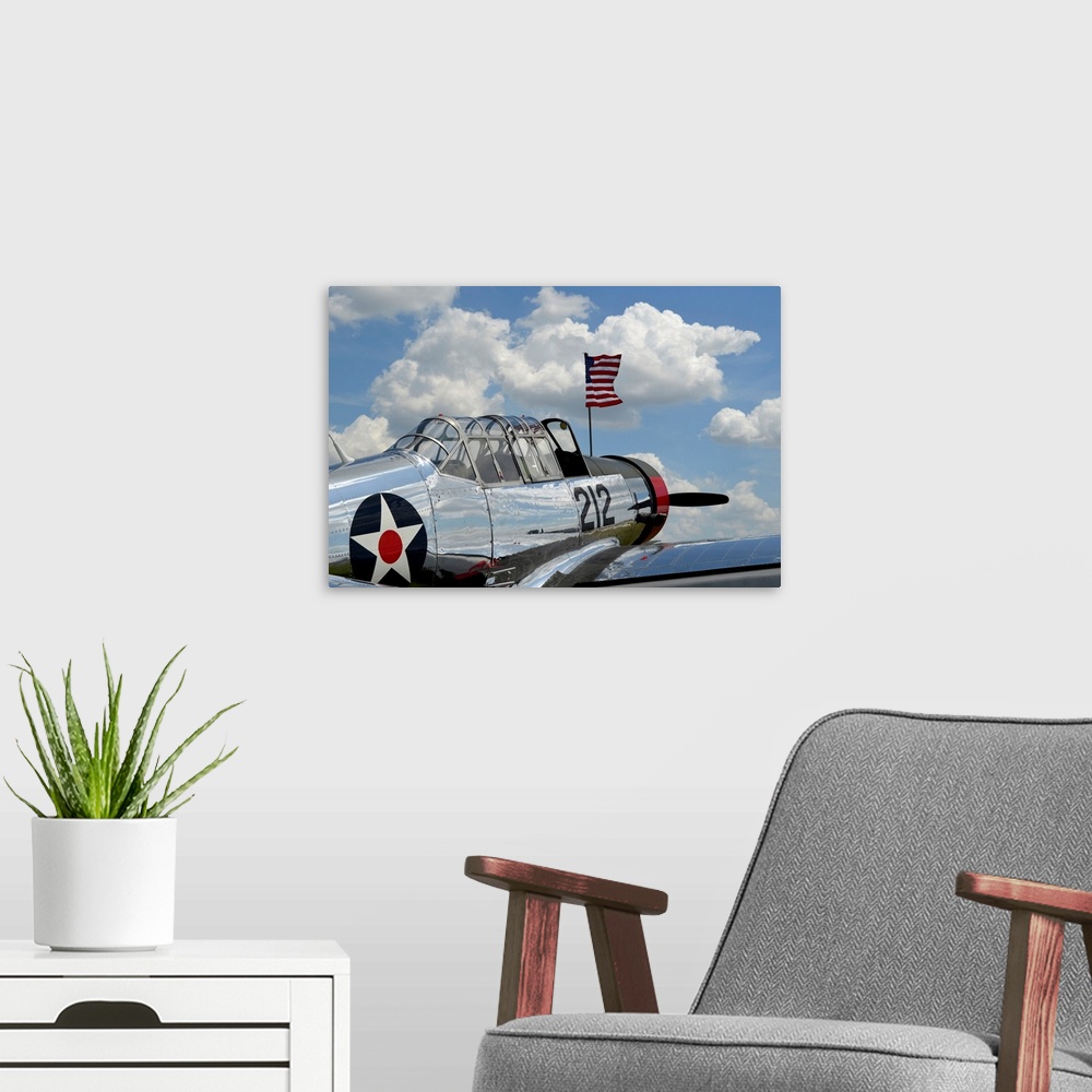 A modern room featuring A BT-13 Valiant trainer aircraft with American Flag.