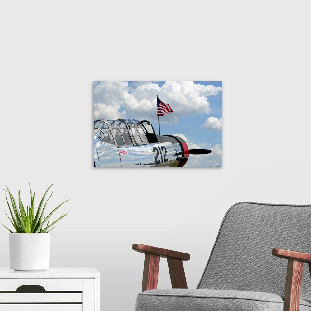 A modern room featuring A BT-13 Valiant trainer aircraft with American Flag.