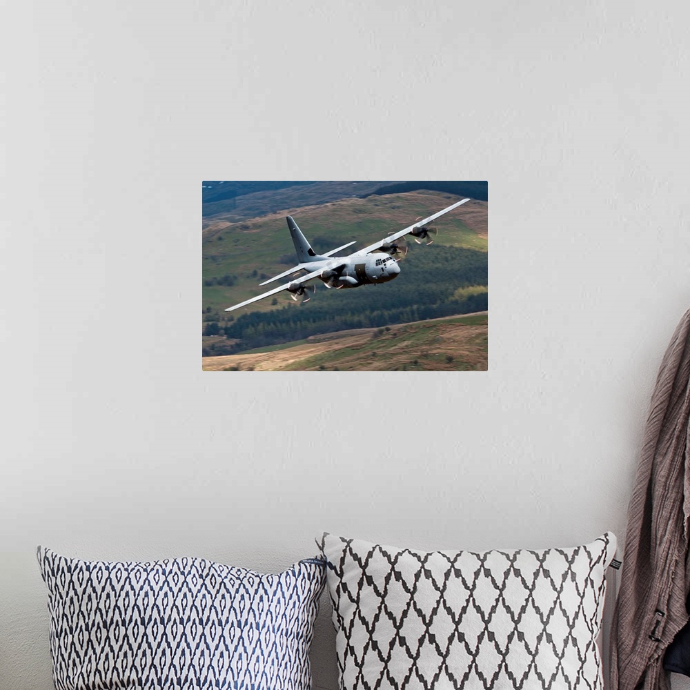 A bohemian room featuring A C-130 Hercules of the Royal Air Force flying over North Wales, United Kingdom.