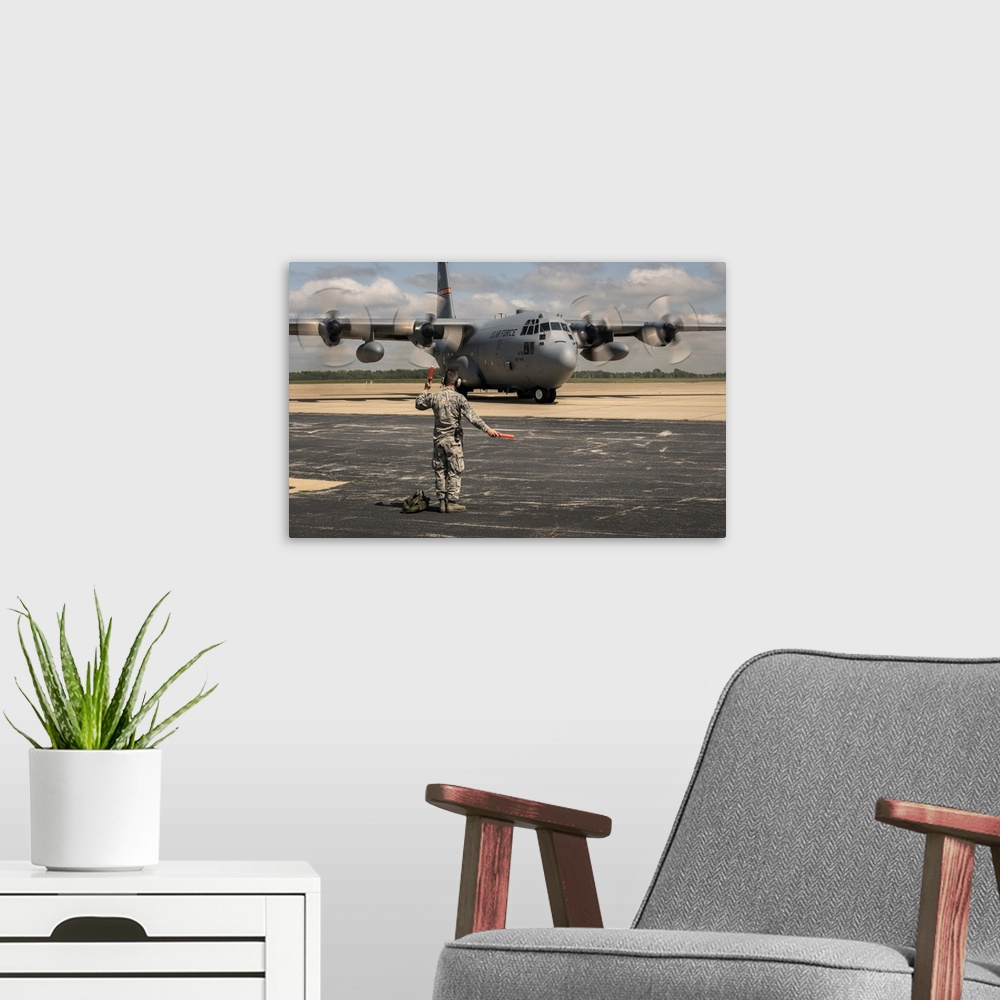 A modern room featuring A C-130H Hercules gets ready to support Hurricane Harvey relief efforts.