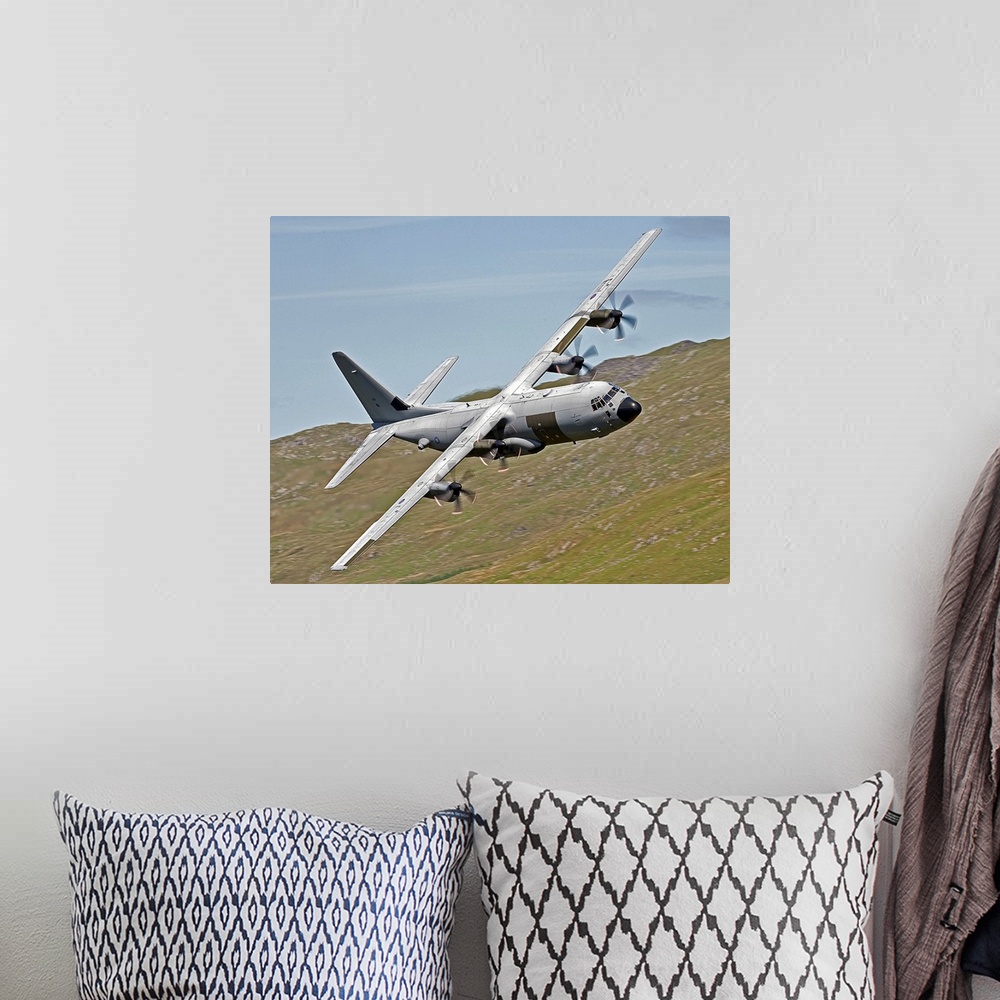 A bohemian room featuring A C-130J Super Hercules low flying over North Wales on a training flight. The C-130J is a compreh...