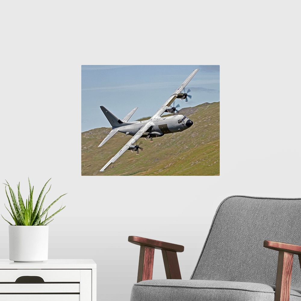 A modern room featuring A C-130J Super Hercules low flying over North Wales on a training flight. The C-130J is a compreh...