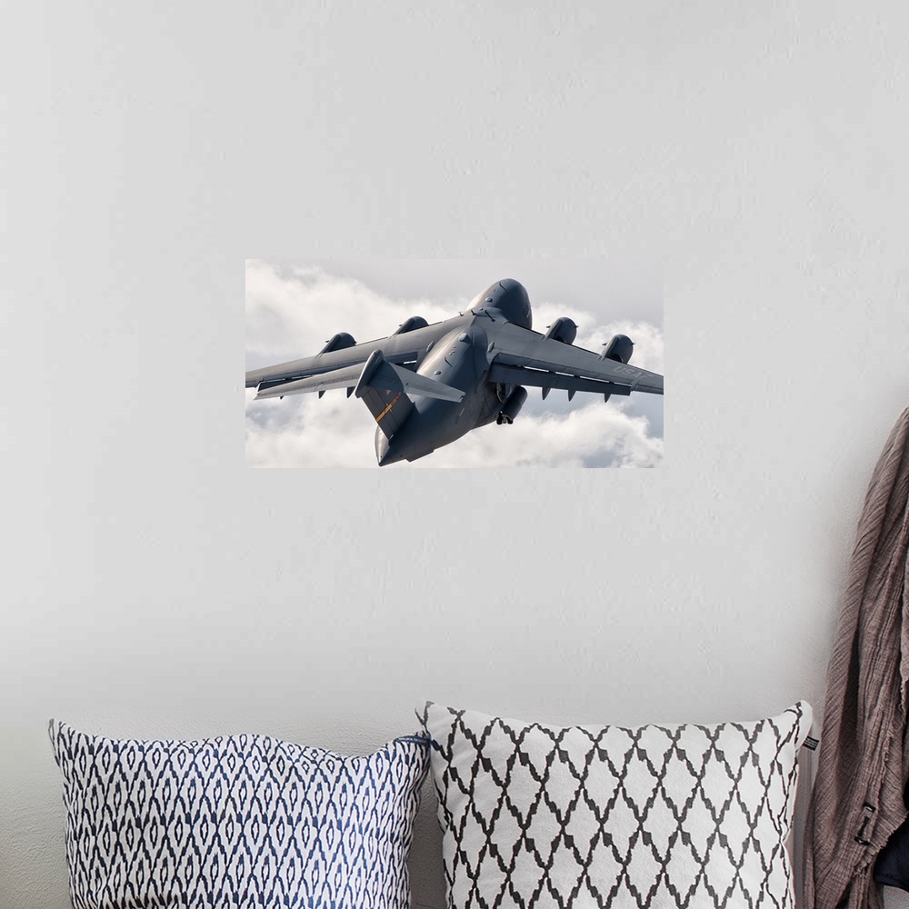 A bohemian room featuring Rear view of a C-17 Globemaster flying above the clouds over Nellis Air Force Base, Nevada.