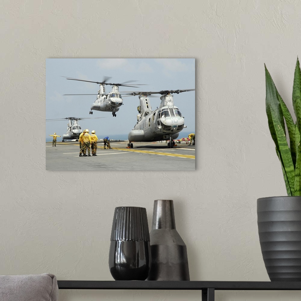 A modern room featuring February 13, 2011 - A U.S. Marine Corps CH-46E Sea Knight helicopter takes off from the flight de...
