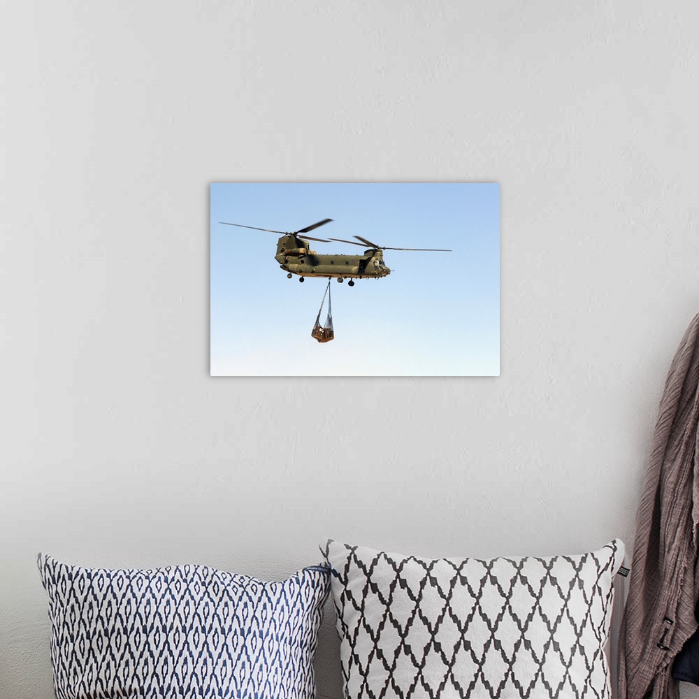 A bohemian room featuring A CH-47 Chinook of the Royal Air Force transports a sling load of pallets.